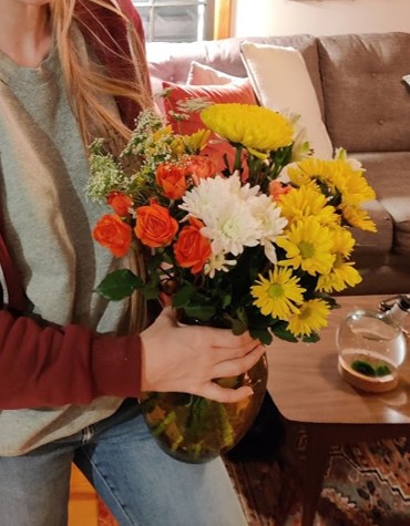 A woman holding a bouquet of flowers.